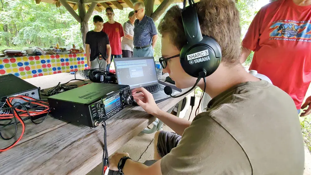 A young operator works HF at a club field event
