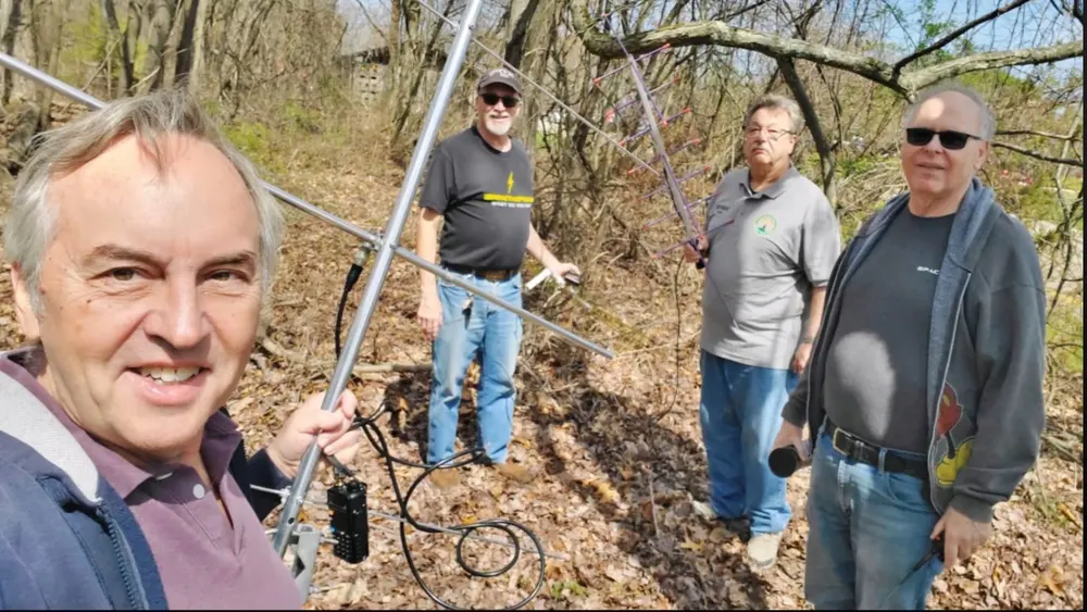 Members work amateur satellites with a handheld beam antenna