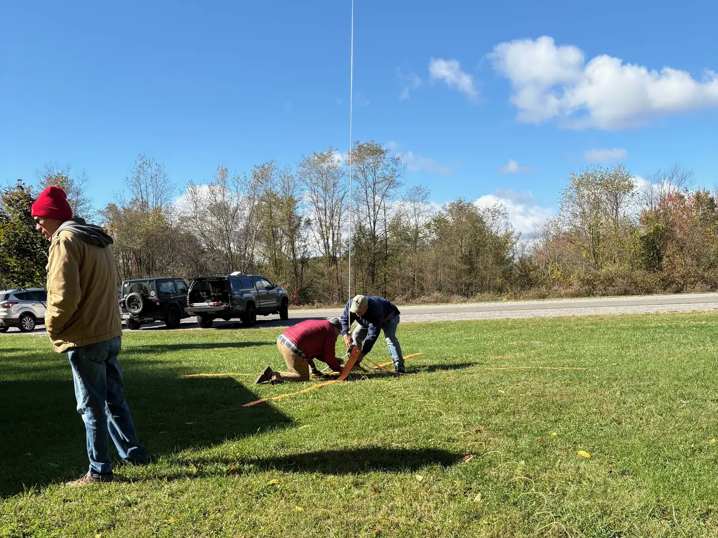 Members stake out the orange radials for the vertical antenna